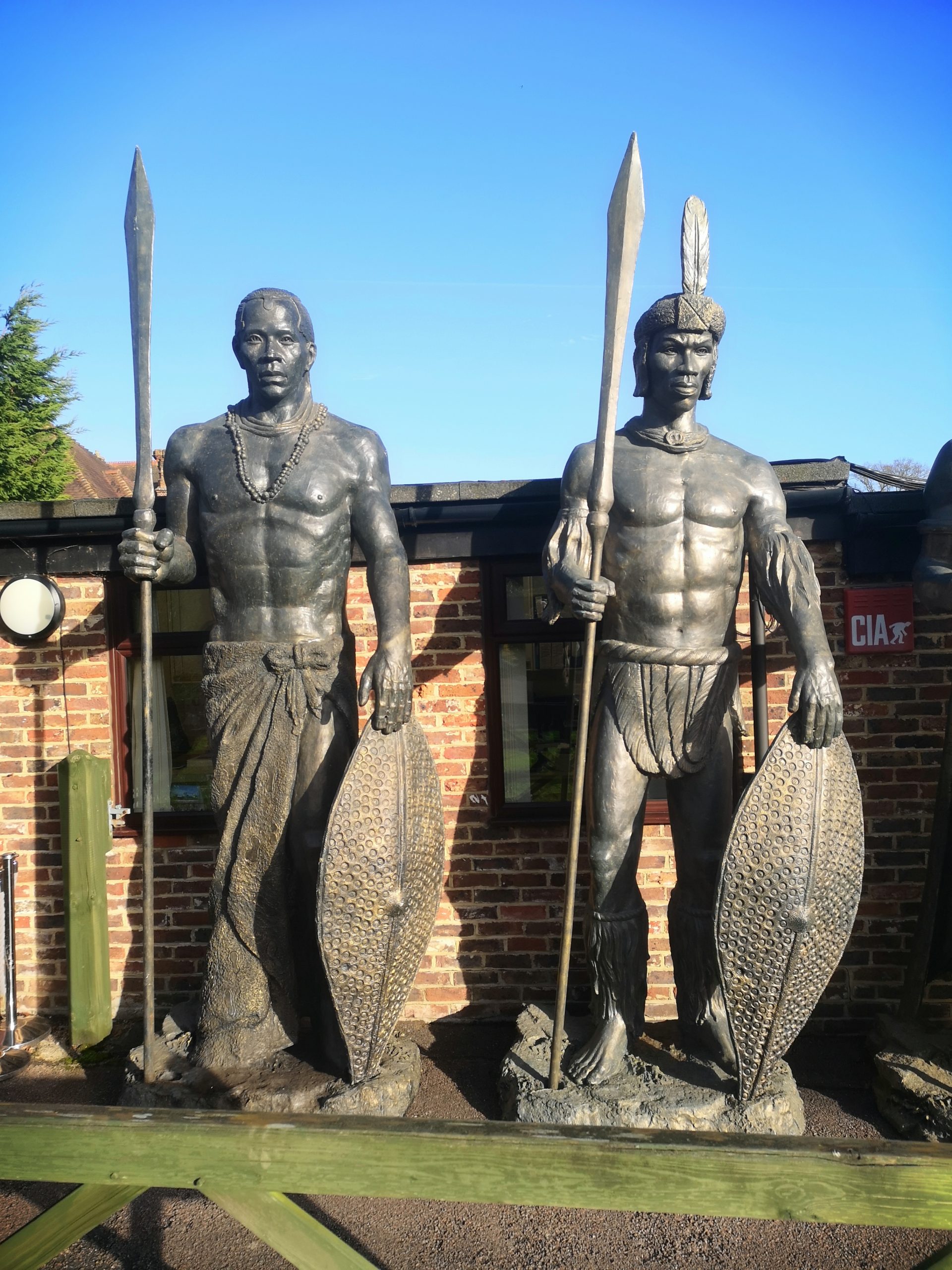 An impressive and colossal patinted fibreglass figure of a Zulu warrior