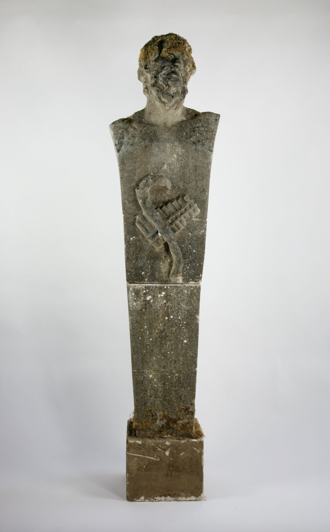 A carved stone term figure