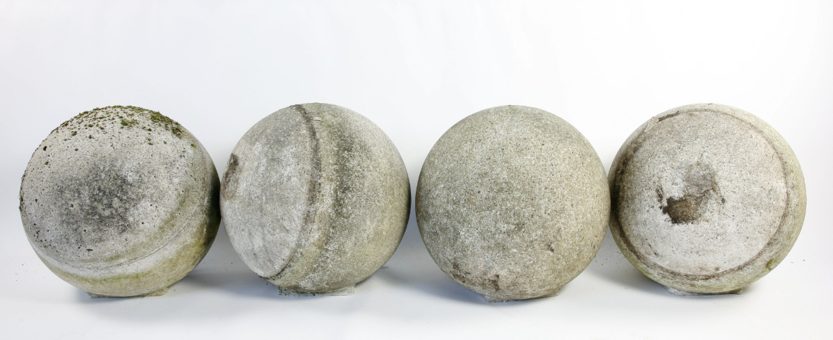 A set of four large composition stone balls