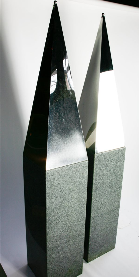 †A pair of stainless steel obelisks on granite bases
